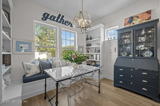 a living room with furniture kitchen view and a large window
