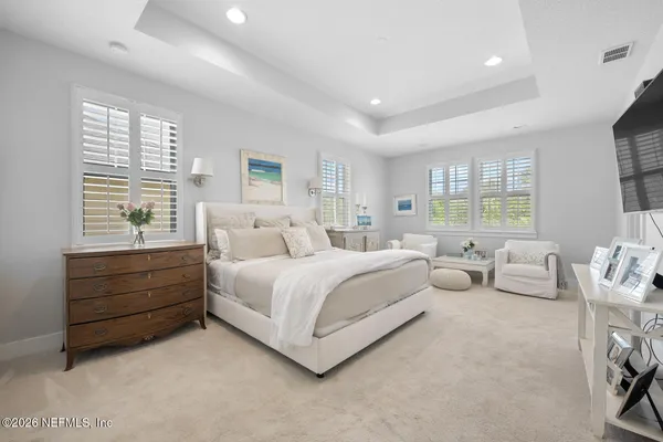 a bathroom with a granite countertop double vanity sink and a mirror