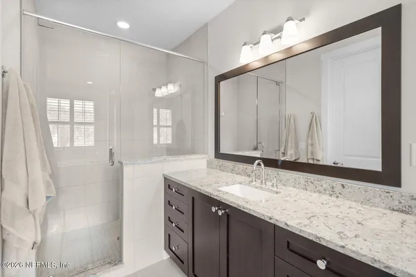 a white bath tub sitting in a bathroom next to a window