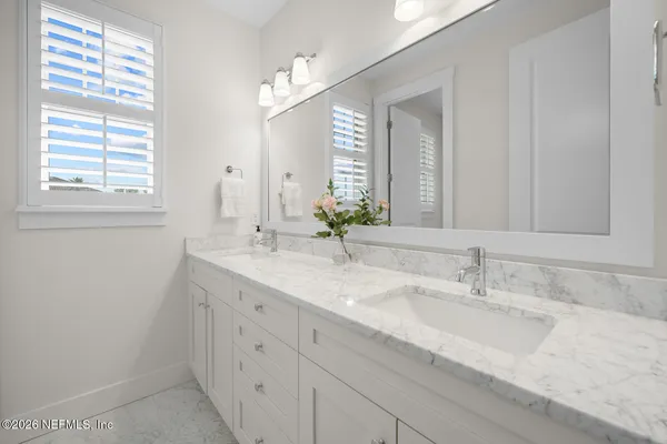 a spacious bedroom with a bed and a window