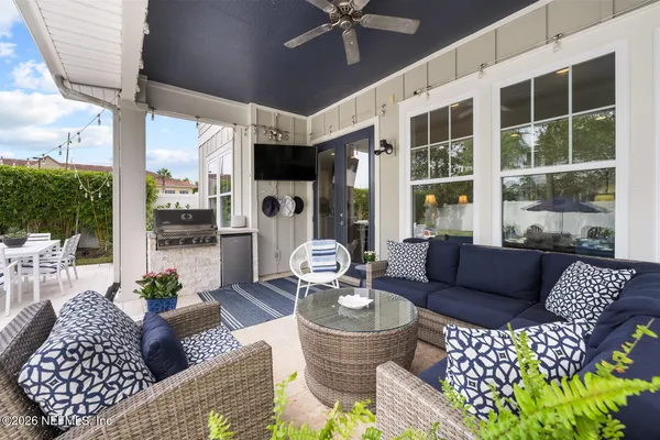 a view of a patio with table and chairs and potted plants