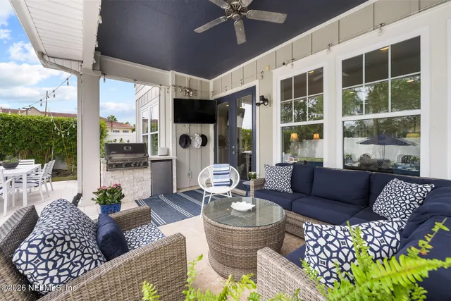 a view of a patio with table and chairs and potted plants