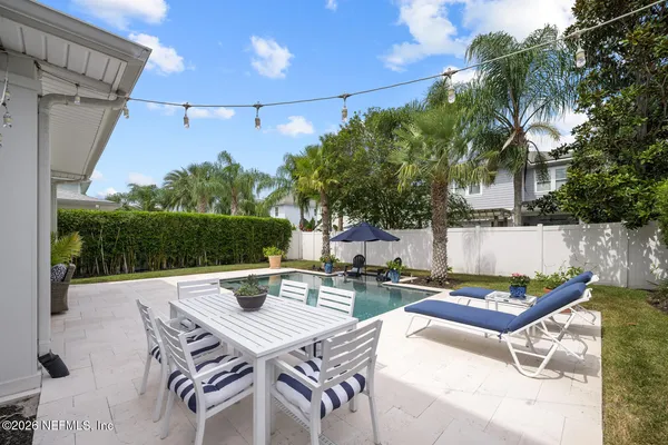 a view of a dinning table and chairs in the patio