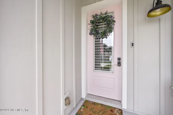 a dining room with furniture a chandelier and wooden floor
