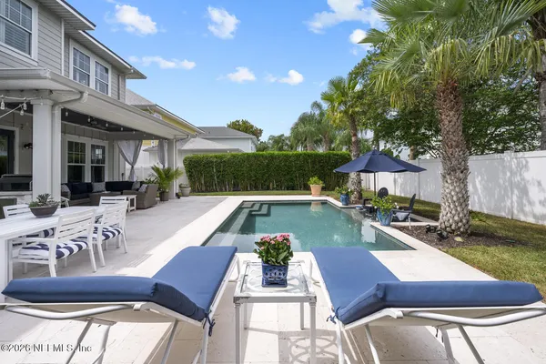 a view of a backyard and swimming pool