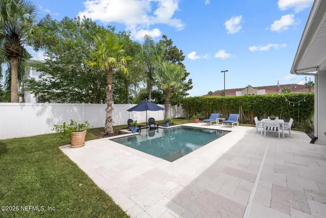 a view of a house with swimming pool and sitting area