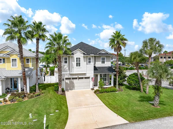 an aerial view of a house with a garden and a yard