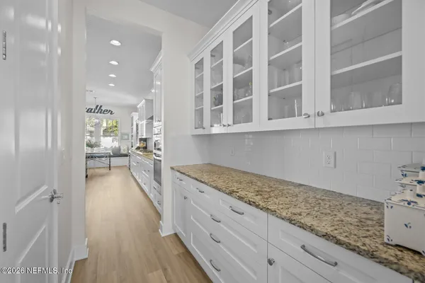 a kitchen with a table chairs refrigerator and microwave
