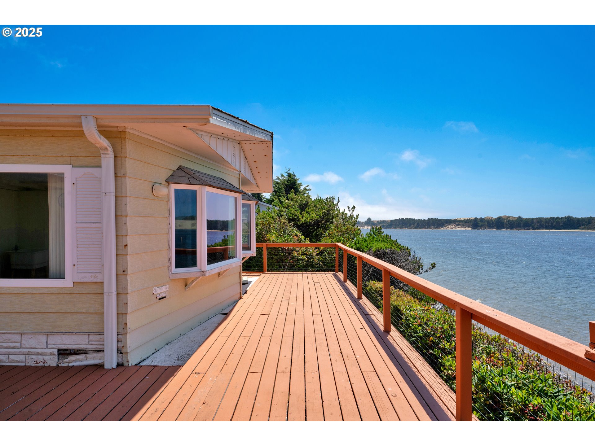 1601 Rhododendron Drive, Unit 610 Florence, OR 97439 - Photo 11 of 48 a view of balcony with staircase and wooden floor