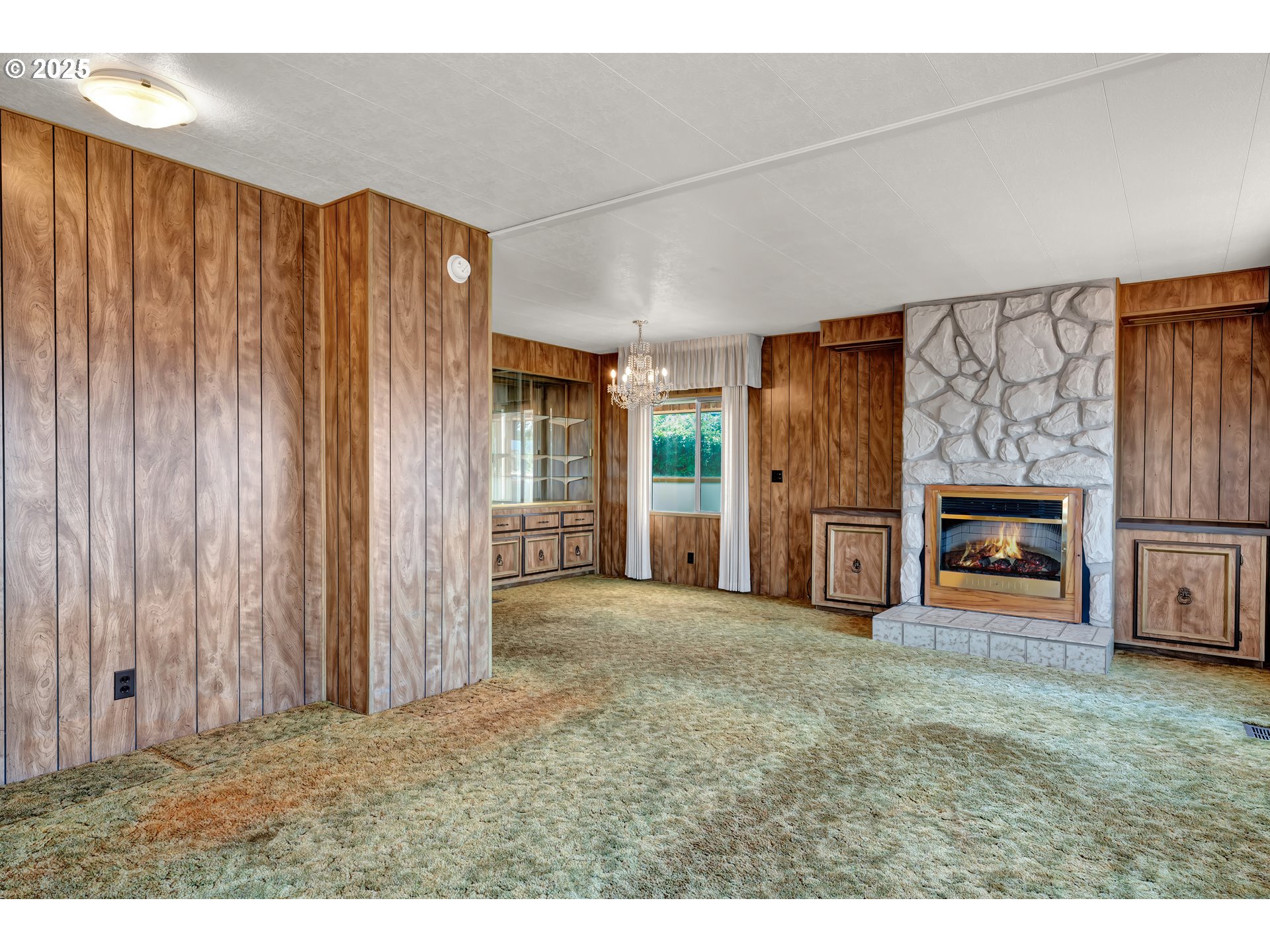 1601 Rhododendron Drive, Unit 610 Florence, OR 97439 - Photo 20 of 48 a view of an empty room with a fireplace and a window