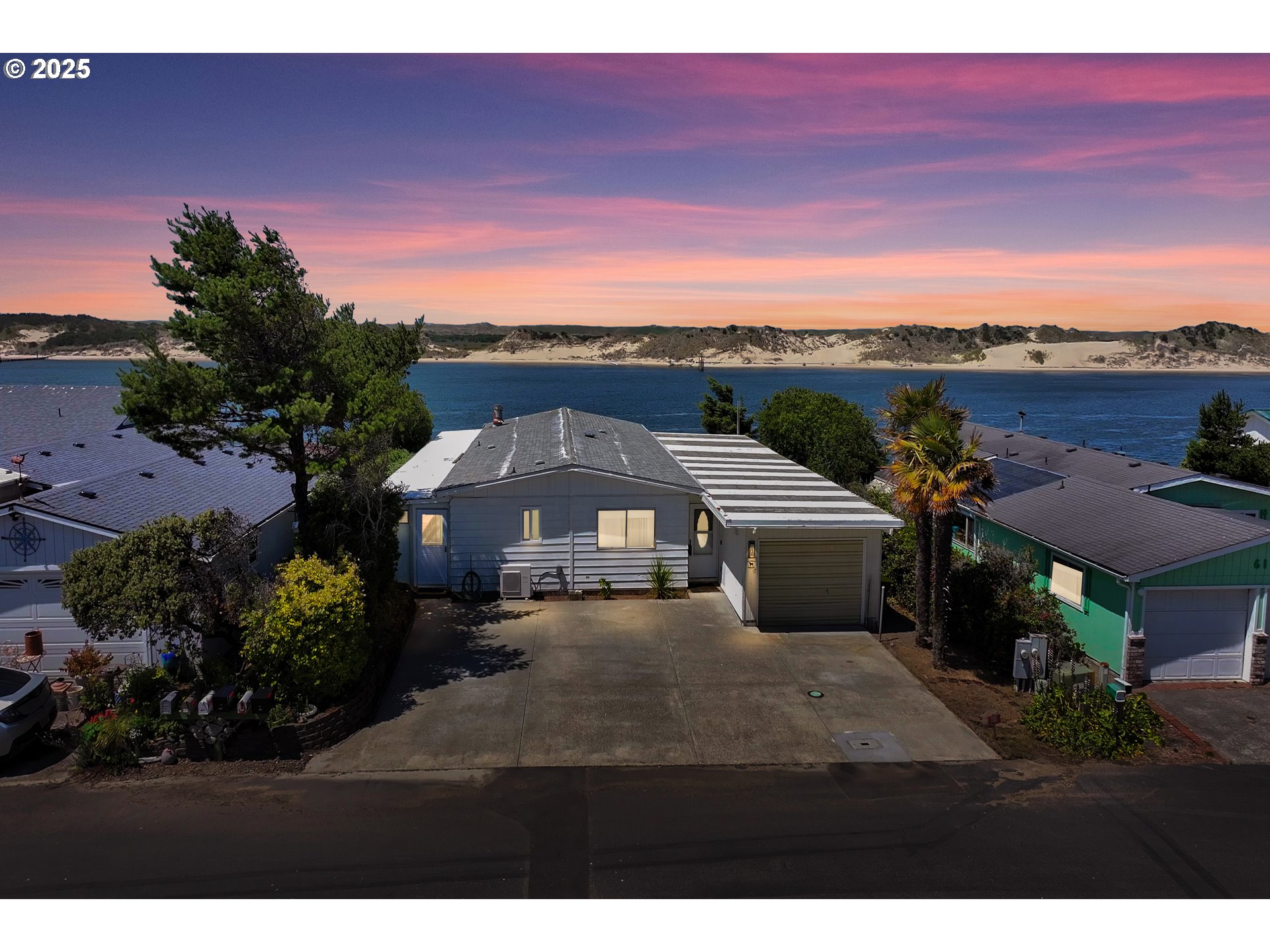 1601 Rhododendron Drive, Unit 610 Florence, OR 97439 - Photo 2 of 48 a front view of a house with a yard