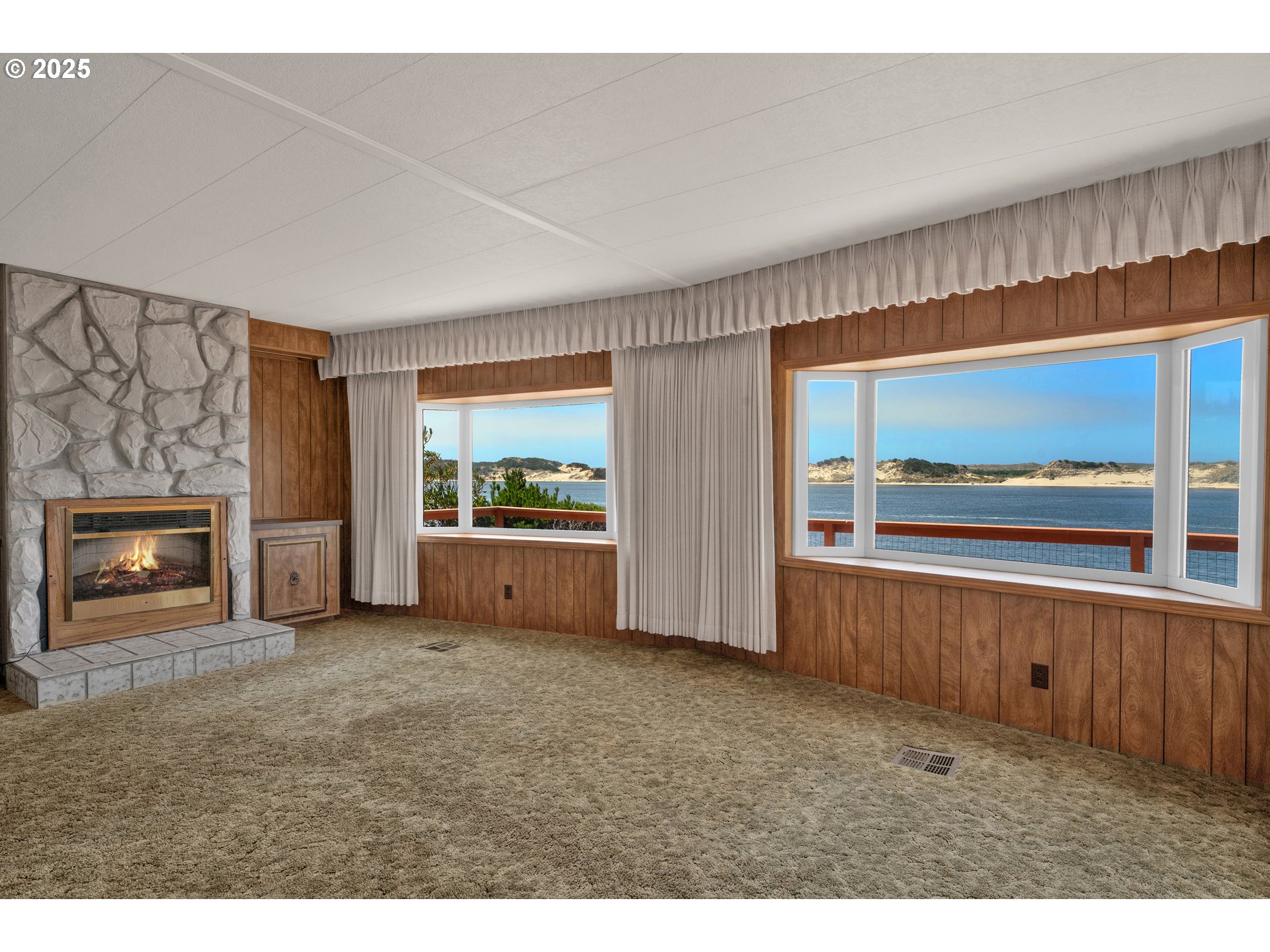 1601 Rhododendron Drive, Unit 610 Florence, OR 97439 - Photo 23 of 48 a view of an empty room with window and fire place