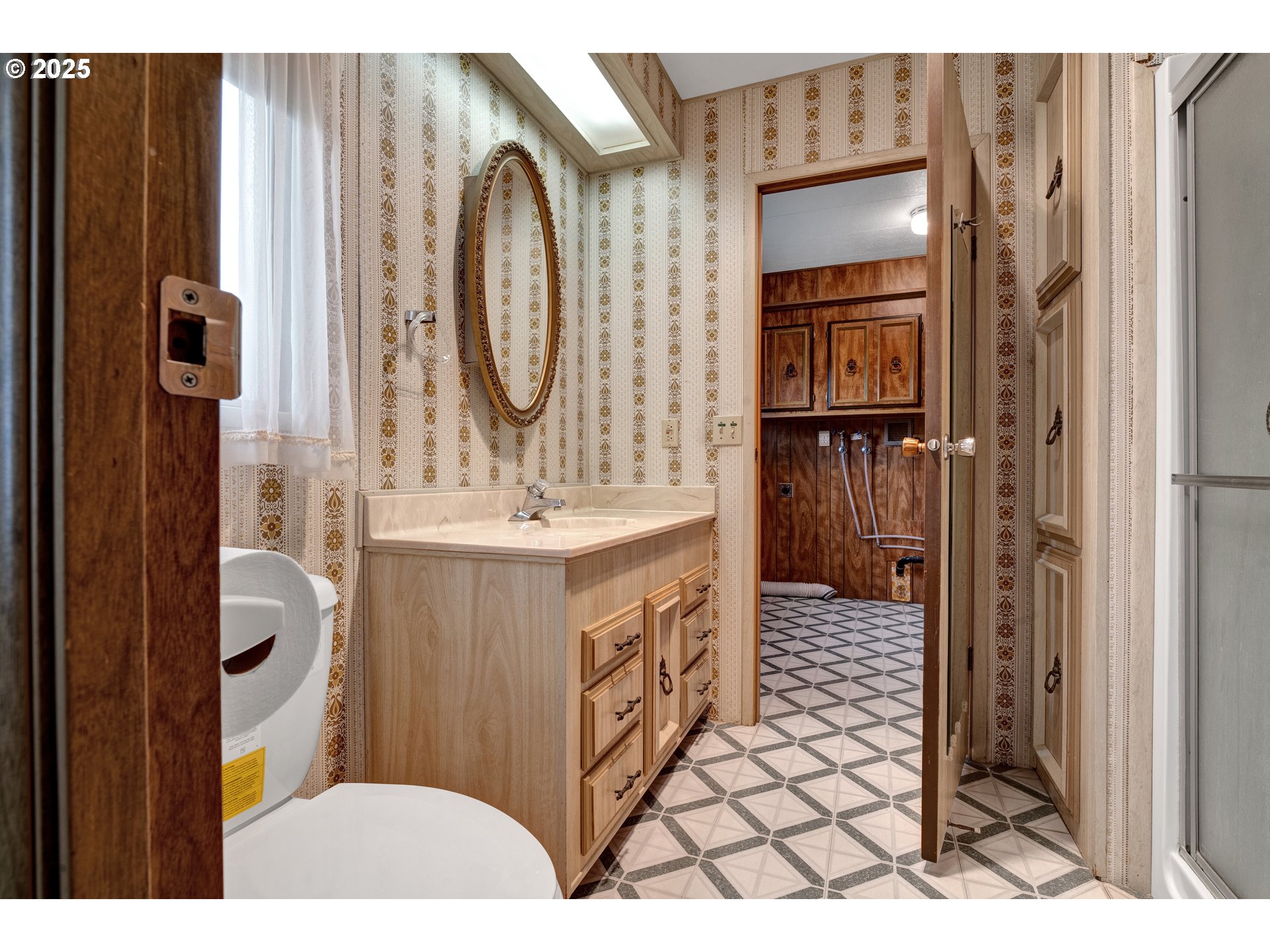 1601 Rhododendron Drive, Unit 610 Florence, OR 97439 - Photo 34 of 48 a bathroom with a sink a vanity and a mirror