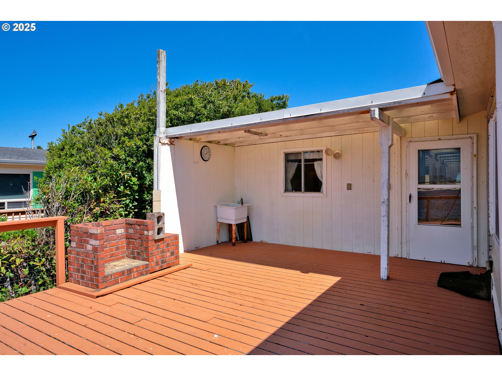 1601 Rhododendron Drive, Unit 610 Florence, OR 97439 - Photo 10 of 48 a view of a backyard with wooden floor and seating space