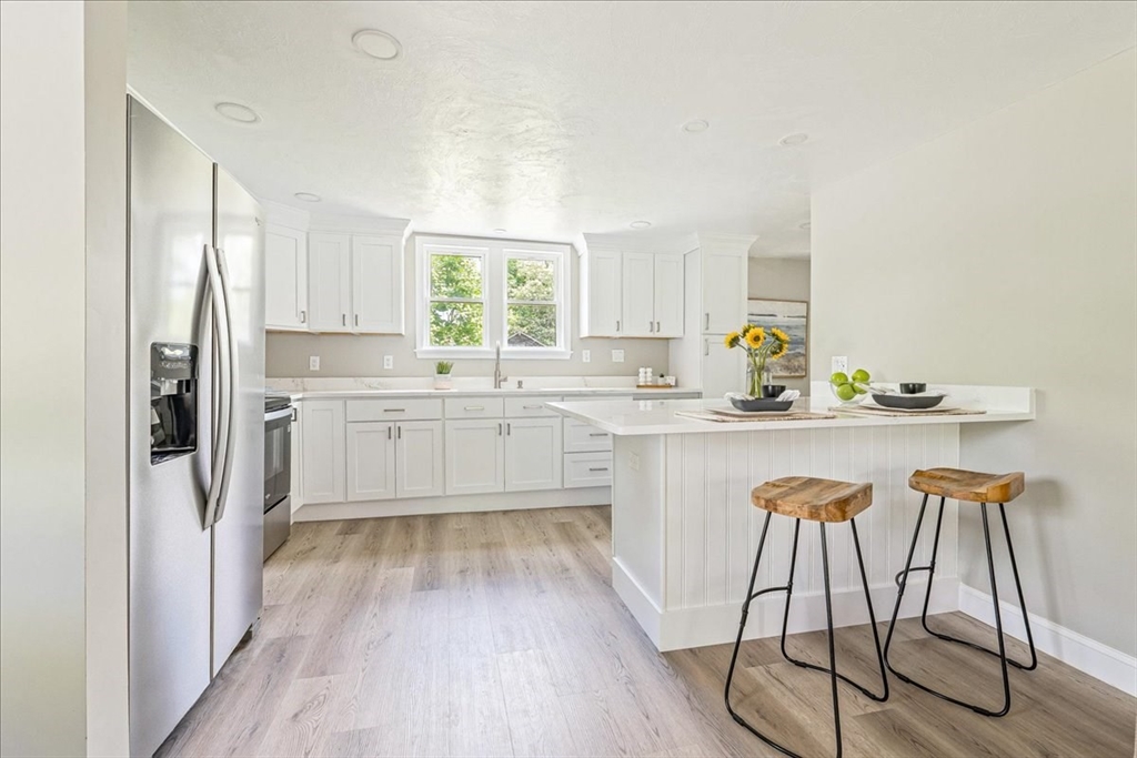 1009 Point Road Marion, MA 02738 - Photo 11 of 31 a kitchen with a sink a window and chairs