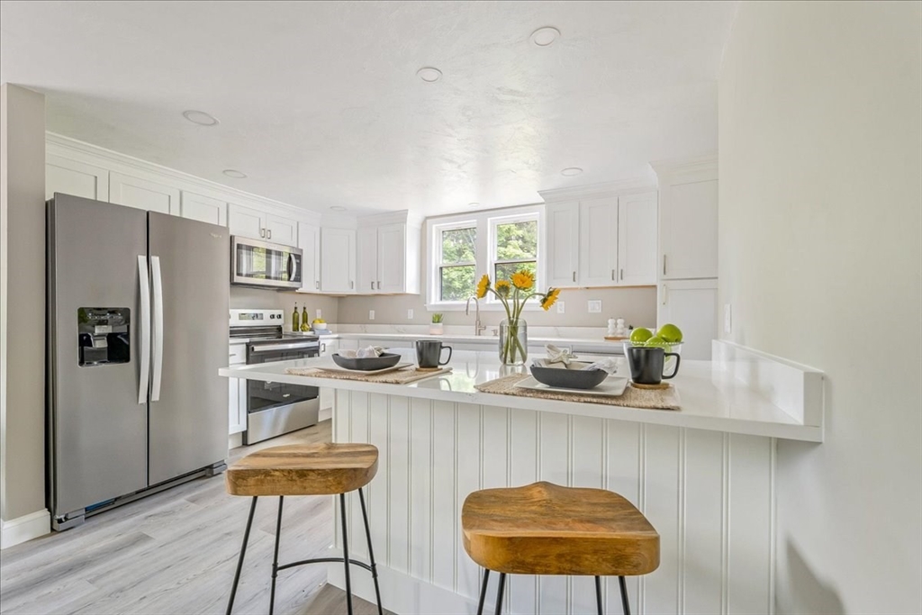 1009 Point Road Marion, MA 02738 - Photo 12 of 31 a kitchen with stainless steel appliances a sink a microwave a refrigerator and a stove