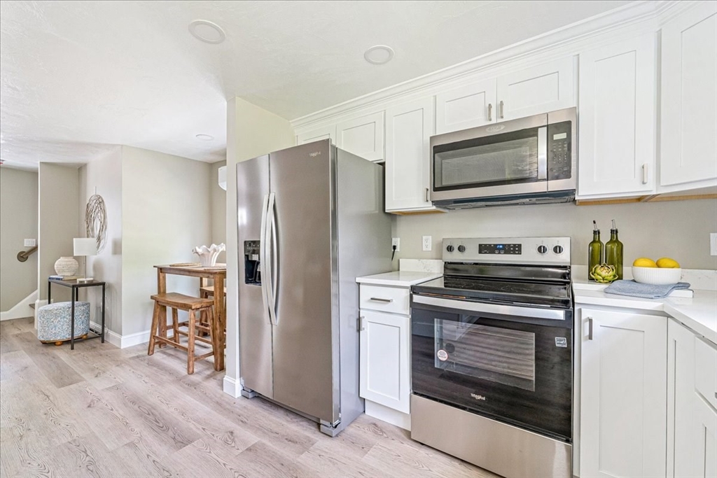 1009 Point Road Marion, MA 02738 - Photo 15 of 31 a kitchen with stainless steel appliances a stove a microwave and cabinets