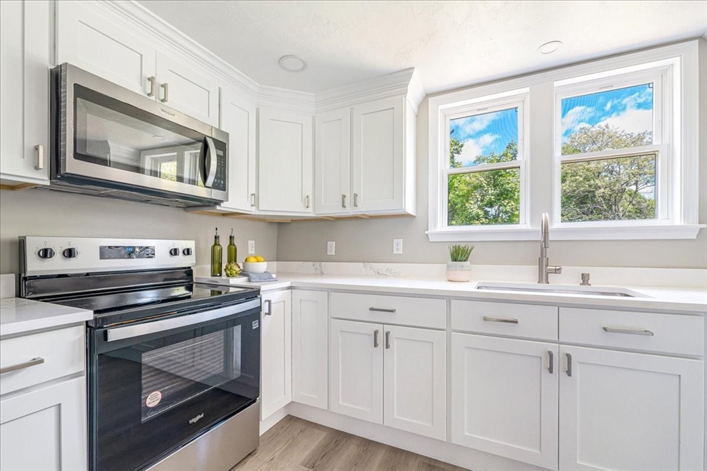 1009 Point Road Marion, MA 02738 - Photo 16 of 31 a kitchen with white cabinets and appliances