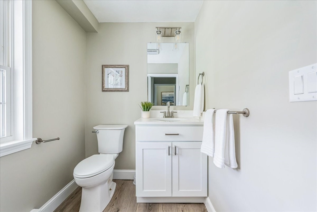 1009 Point Road Marion, MA 02738 - Photo 17 of 31 a bathroom with a toilet sink and mirror