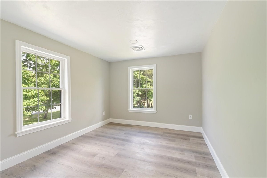 1009 Point Road Marion, MA 02738 - Photo 18 of 31 an empty room with wooden floor and windows
