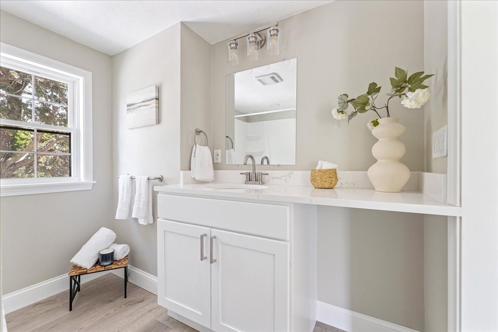 1009 Point Road Marion, MA 02738 - Photo 21 of 31 a bathroom with a sink double vanity and a mirror