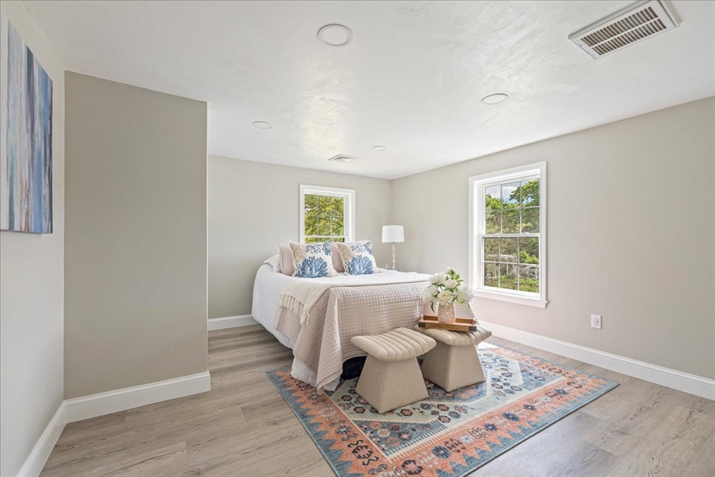 1009 Point Road Marion, MA 02738 - Photo 22 of 31 a bed sitting in a bedroom next to a window