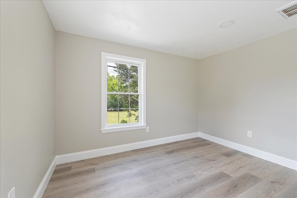 1009 Point Road Marion, MA 02738 - Photo 25 of 31 an empty room with wooden floor and windows