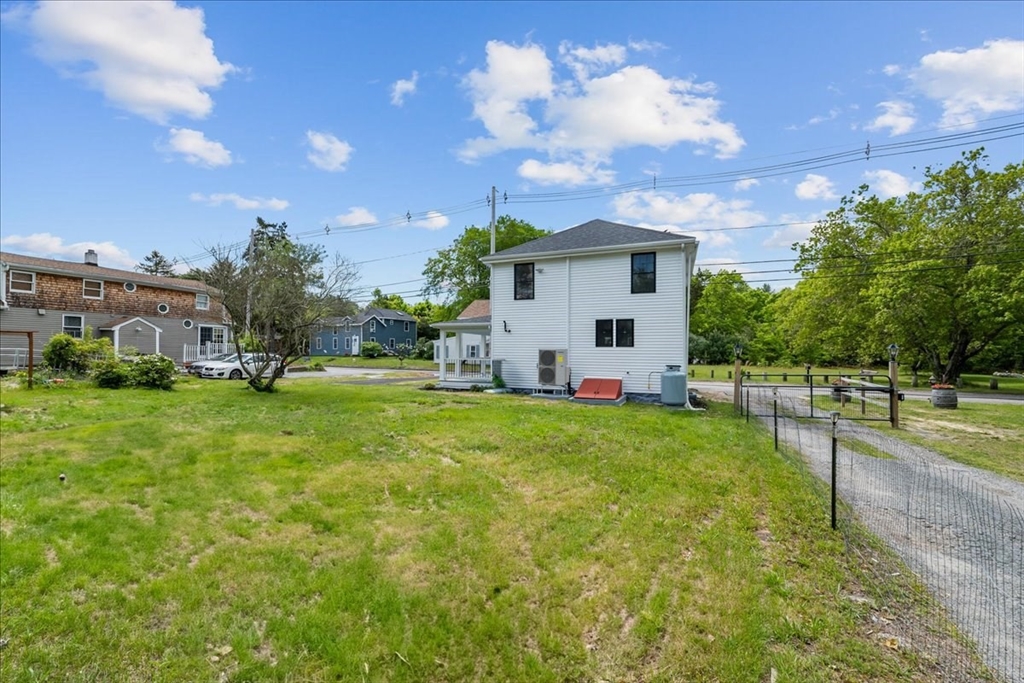 1009 Point Road Marion, MA 02738 - Photo 27 of 31 a view of a white house with a big yard and a large tree