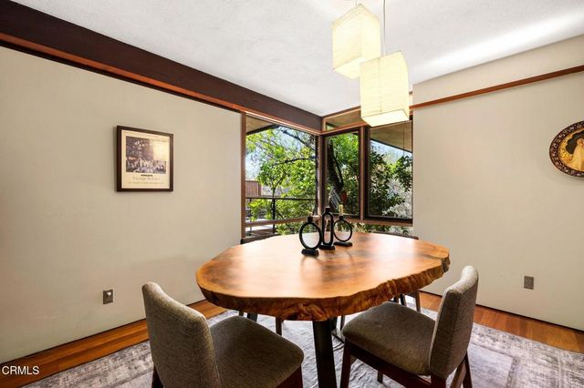a view of a dining room with furniture and window