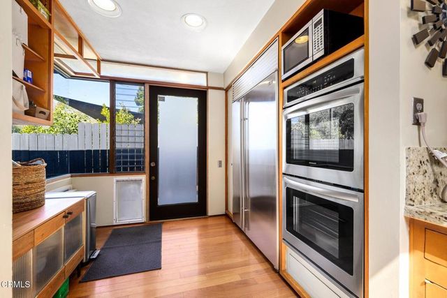 a kitchen with stainless steel appliances a stove a microwave and a refrigerator