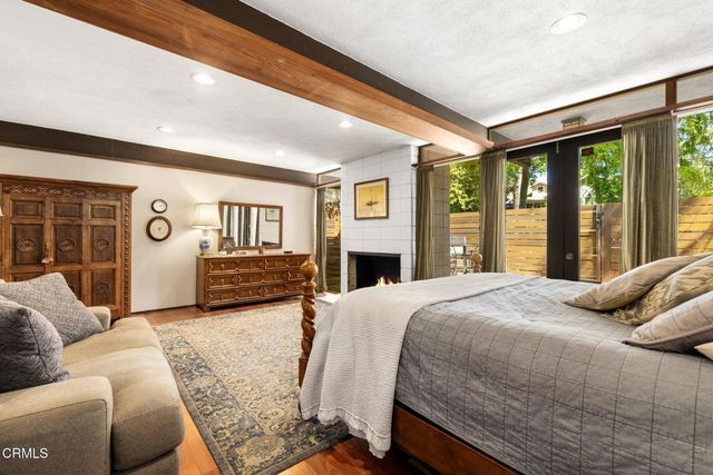 a bedroom with a large bed and a large window