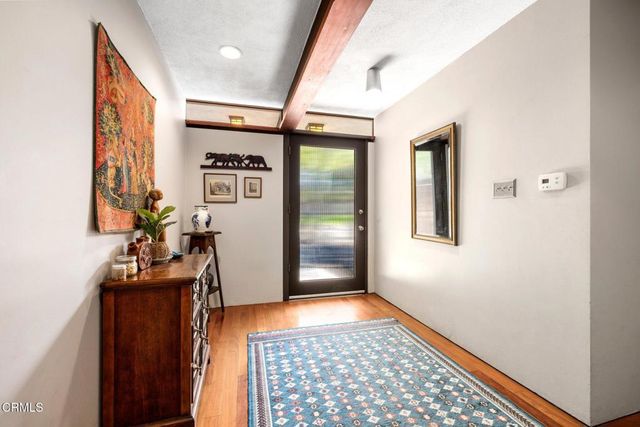 a view of a hallway with a dining room