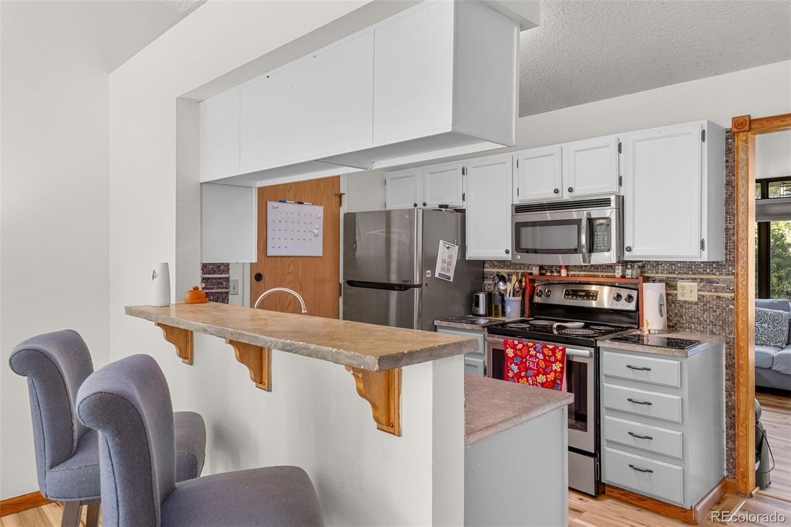 5323 East Sandpiper Avenue Castle Rock, CO 80104 - Photo 11 of 46 a kitchen with stainless steel appliances a refrigerator stove and microwave