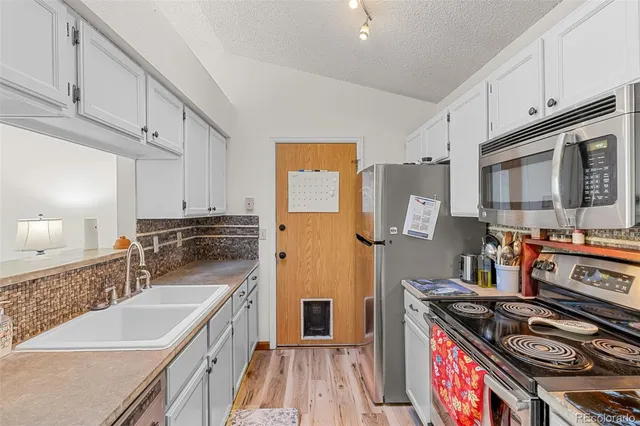 a kitchen with stainless steel appliances granite countertop a stove and a sink