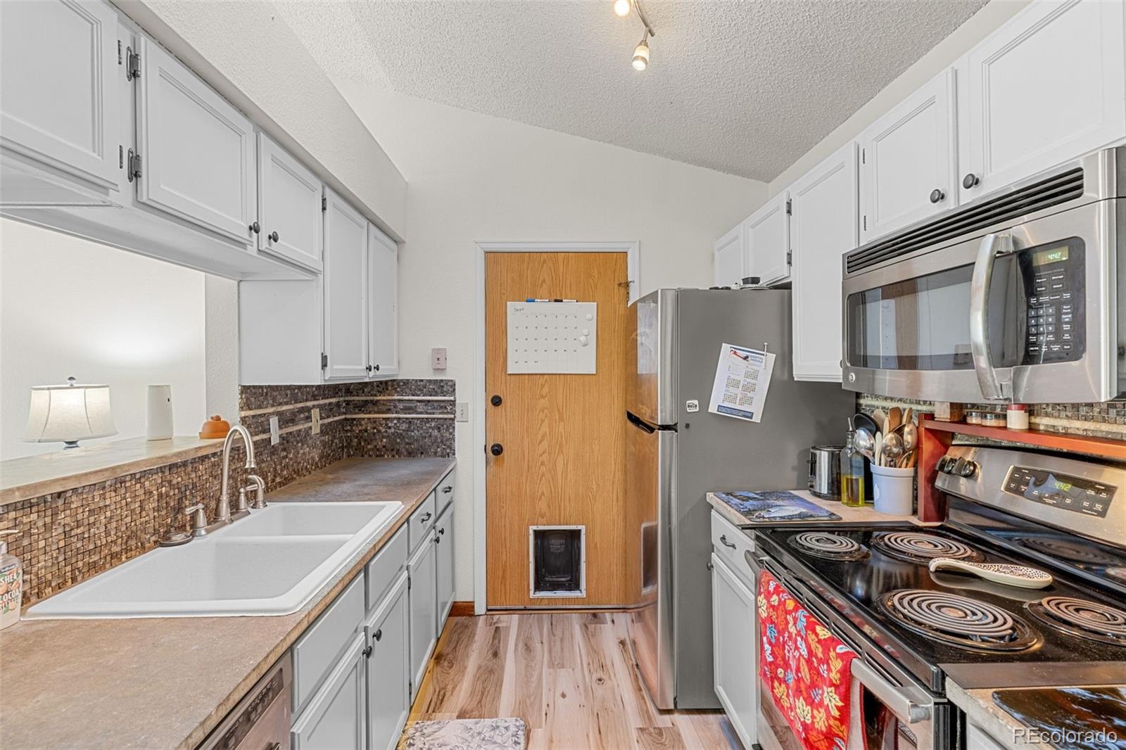 5323 East Sandpiper Avenue Castle Rock, CO 80104 - Photo 12 of 46 a kitchen with stainless steel appliances granite countertop a stove and a sink