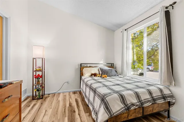 a bedroom with a bed and a large window