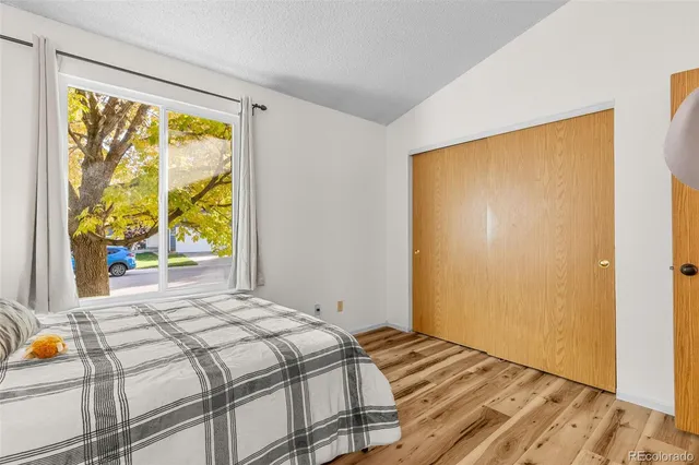 a bedroom with a bed and wooden floor