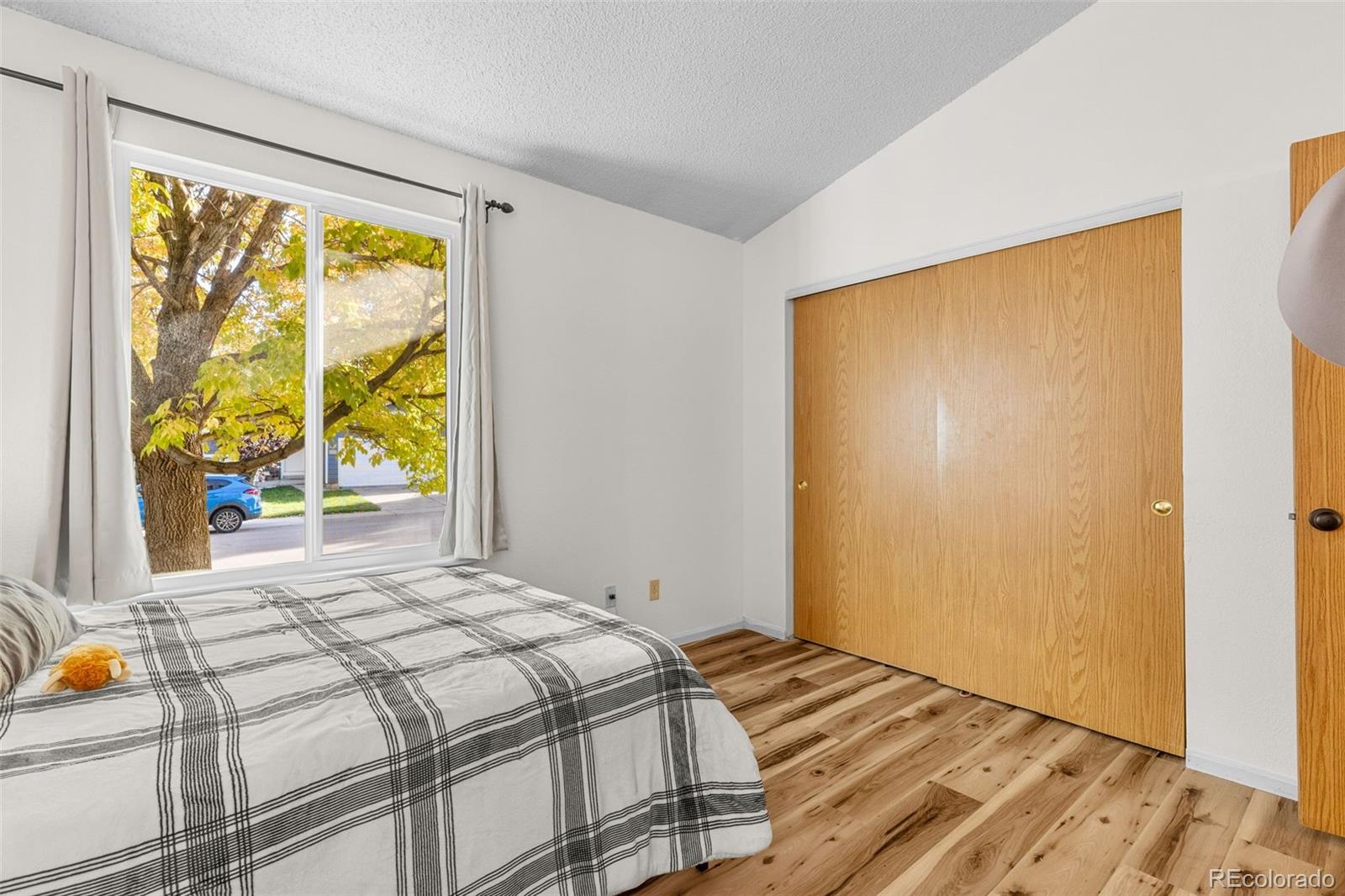 5323 East Sandpiper Avenue Castle Rock, CO 80104 - Photo 20 of 46 a bedroom with a bed and wooden floor