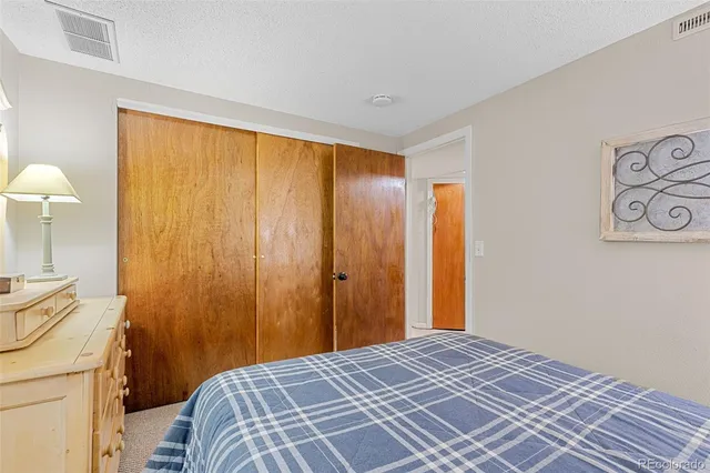 a bedroom with a bed and a lamp