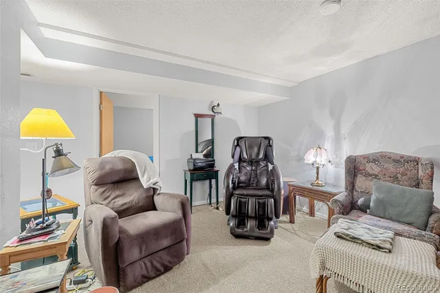 a living room with furniture a lamp and a window