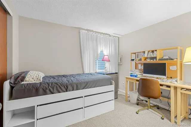 a bedroom with a workspace