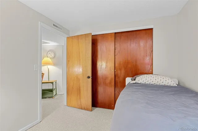 a hallway with sliding door and couch