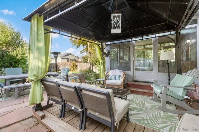 a view of an outdoor dining space with a table and chairs