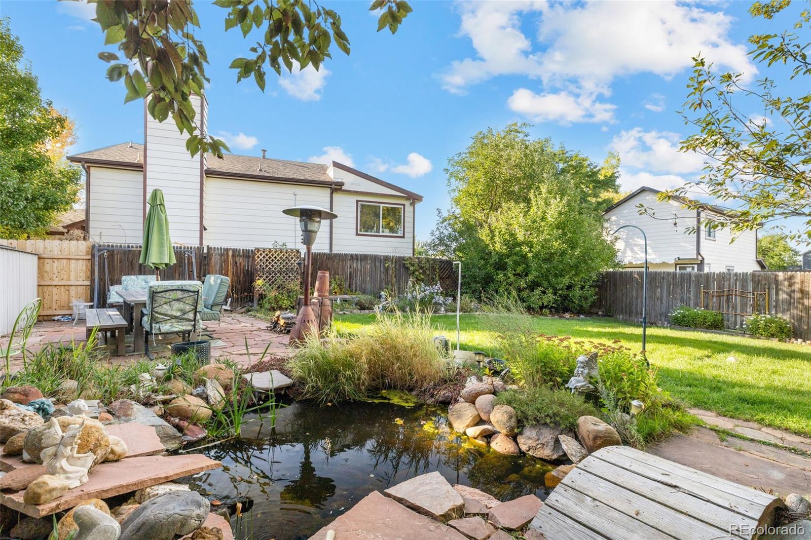 5323 East Sandpiper Avenue Castle Rock, CO 80104 - Photo 39 of 46 a backyard of a house with a garden and outdoor seating
