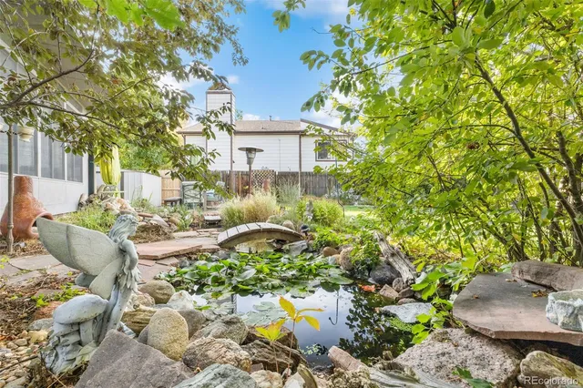 a view of a patio with table and chairs and potted plants