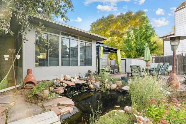 a front view of a house with swimming pool patio and outdoor seating