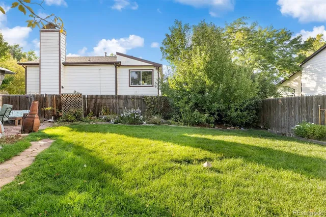 a view of backyard of house with green space