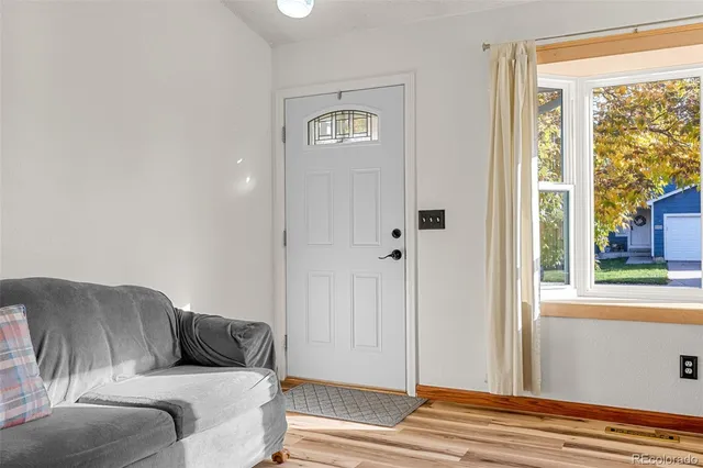 a living room with a couch and a window