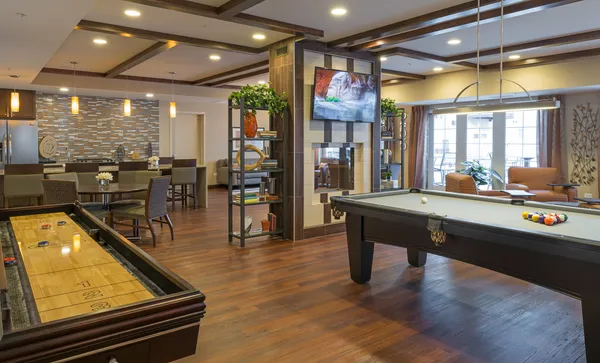 a lobby with furniture pool table table and chairs