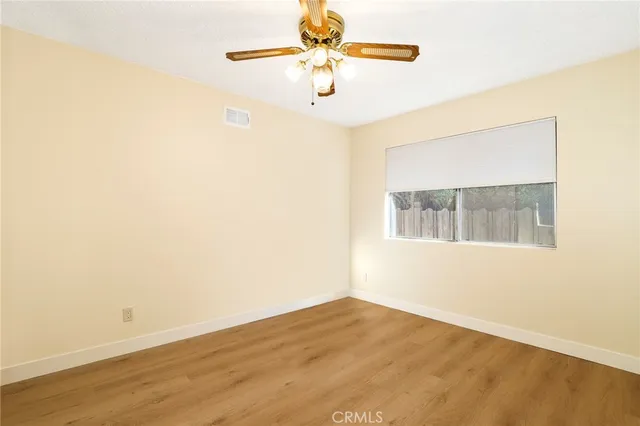 a bedroom with a bed a rug and potted plant